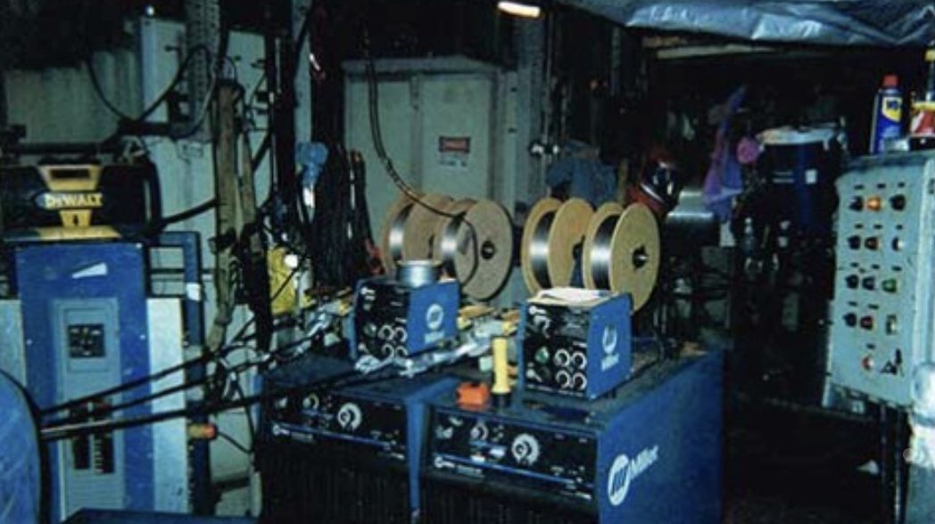 Two dual-drive wire feeders loaded with thermal spray wire on a mill floor.